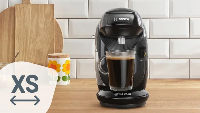 Απεικονίζεται η μηχανή με ένα μεγάλο δοχείο καφέ.